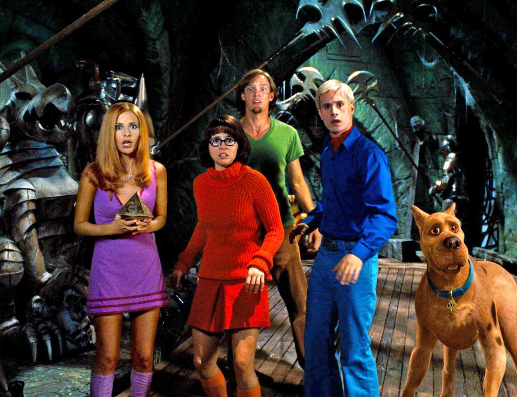 A group of people posing for a picture with a dog
Description automatically generated