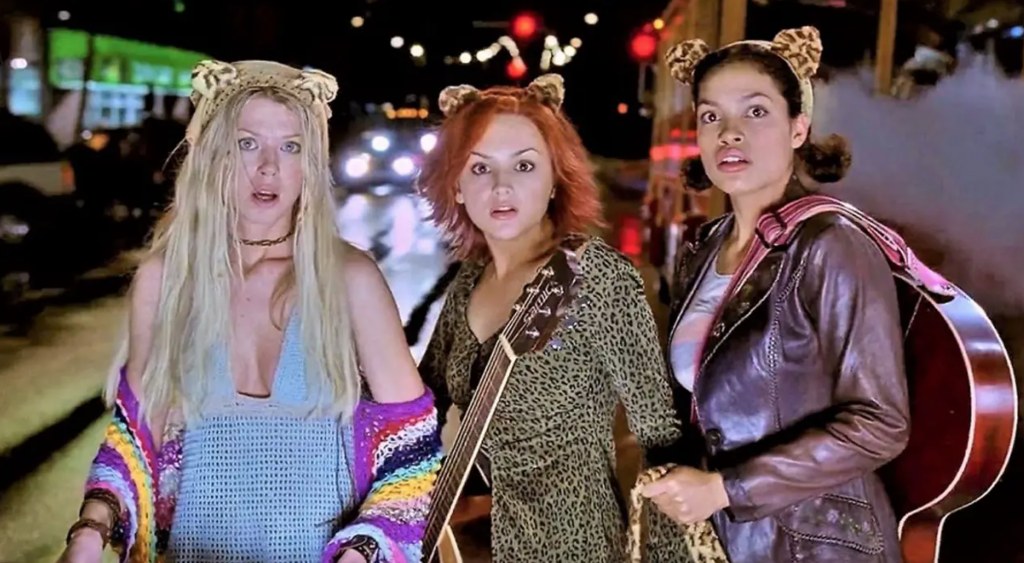 A group of women with a guitar

Description automatically generated