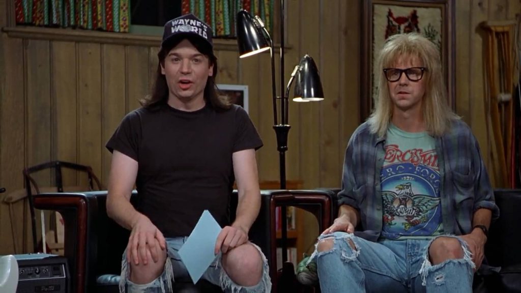 A couple of men sitting in a room

Description automatically generated