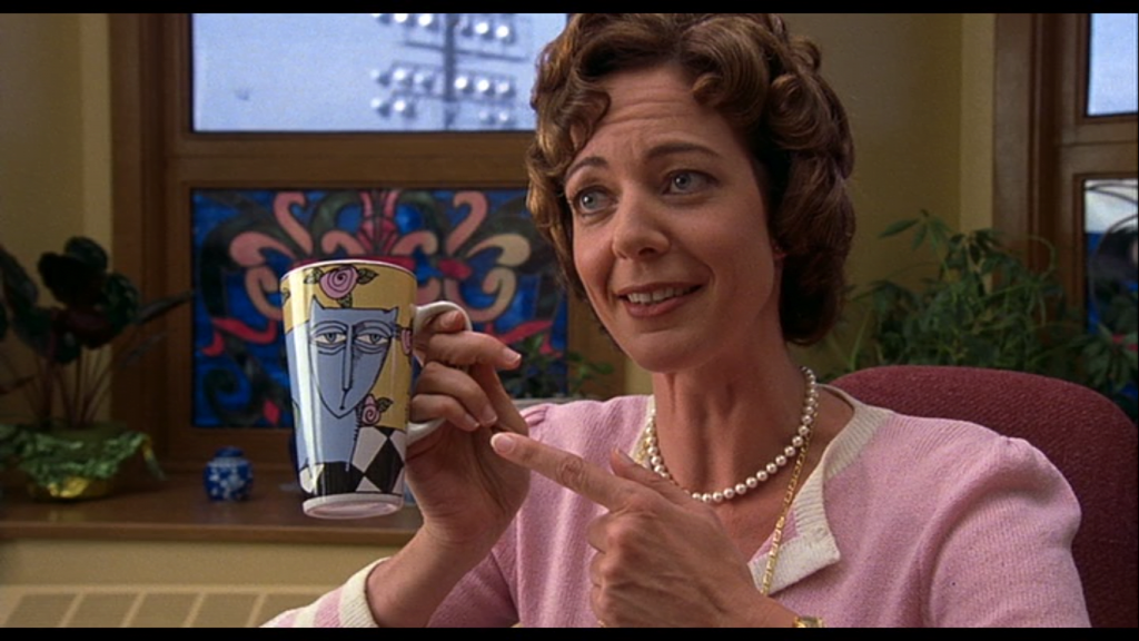 A person holding a mug
Description automatically generated