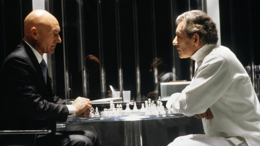 A person in a white shirt playing chess
Description automatically generated